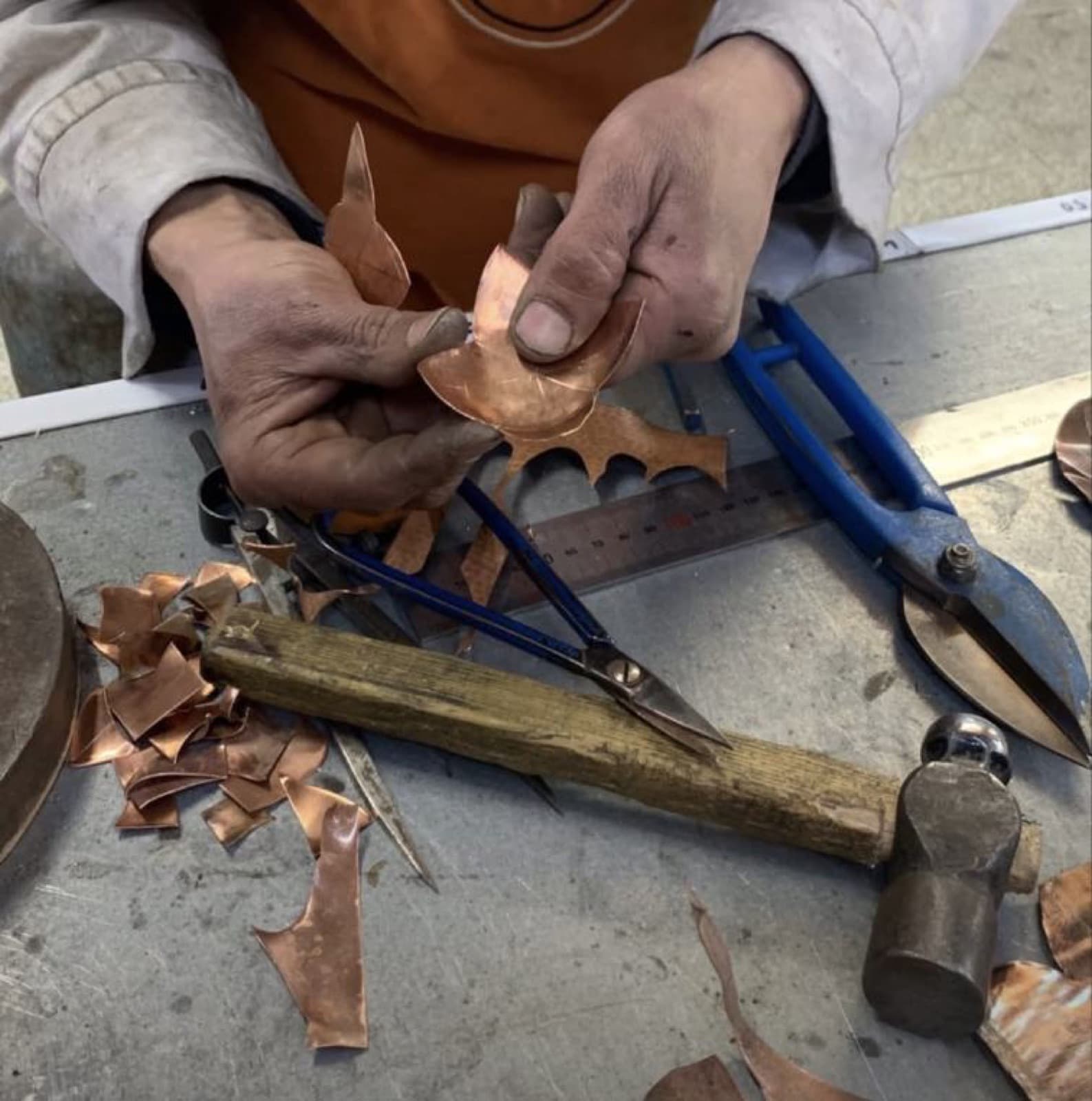 Copper engraver's hands at work