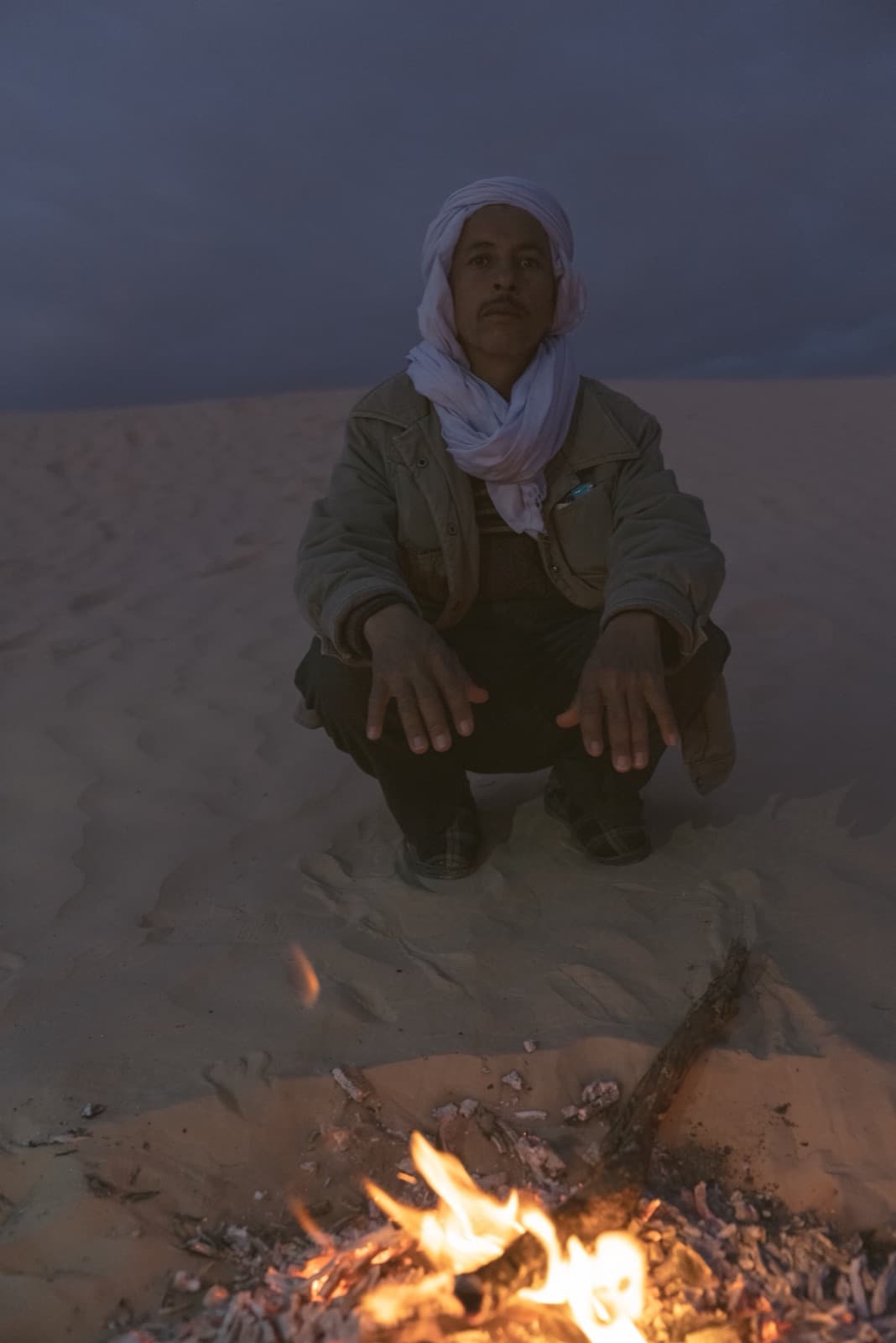 Nomad host by the fire in the dunes